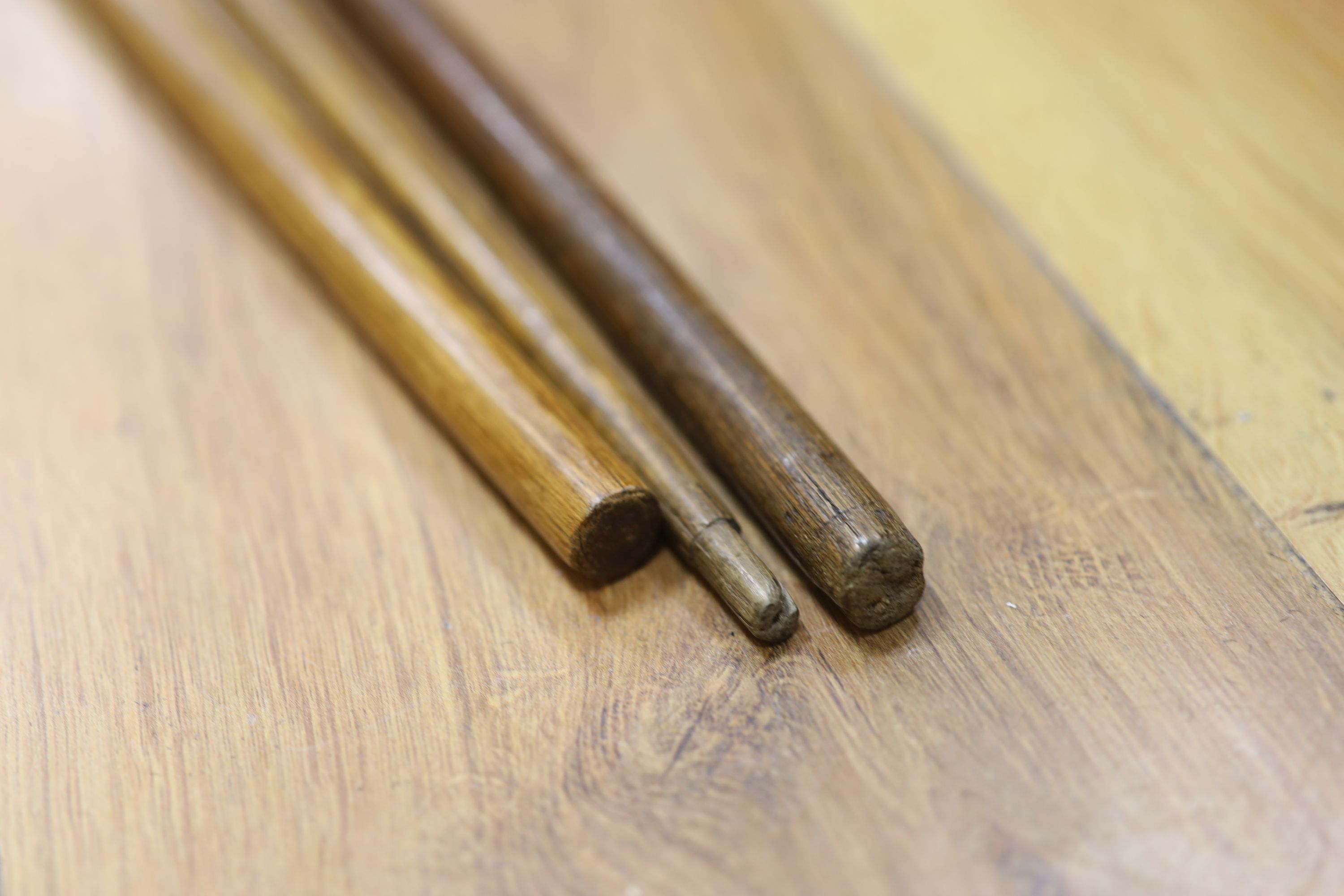 Two ivory mounted fist canes and a marine ivory knot baton, 19th century